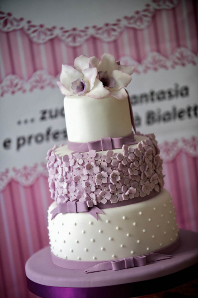 Lila-weiße Hochzeitstorte mit süßer Dekoration